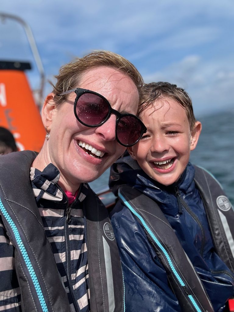 getting wet from the sea spray on a speed boat in Padstow, Cornwall